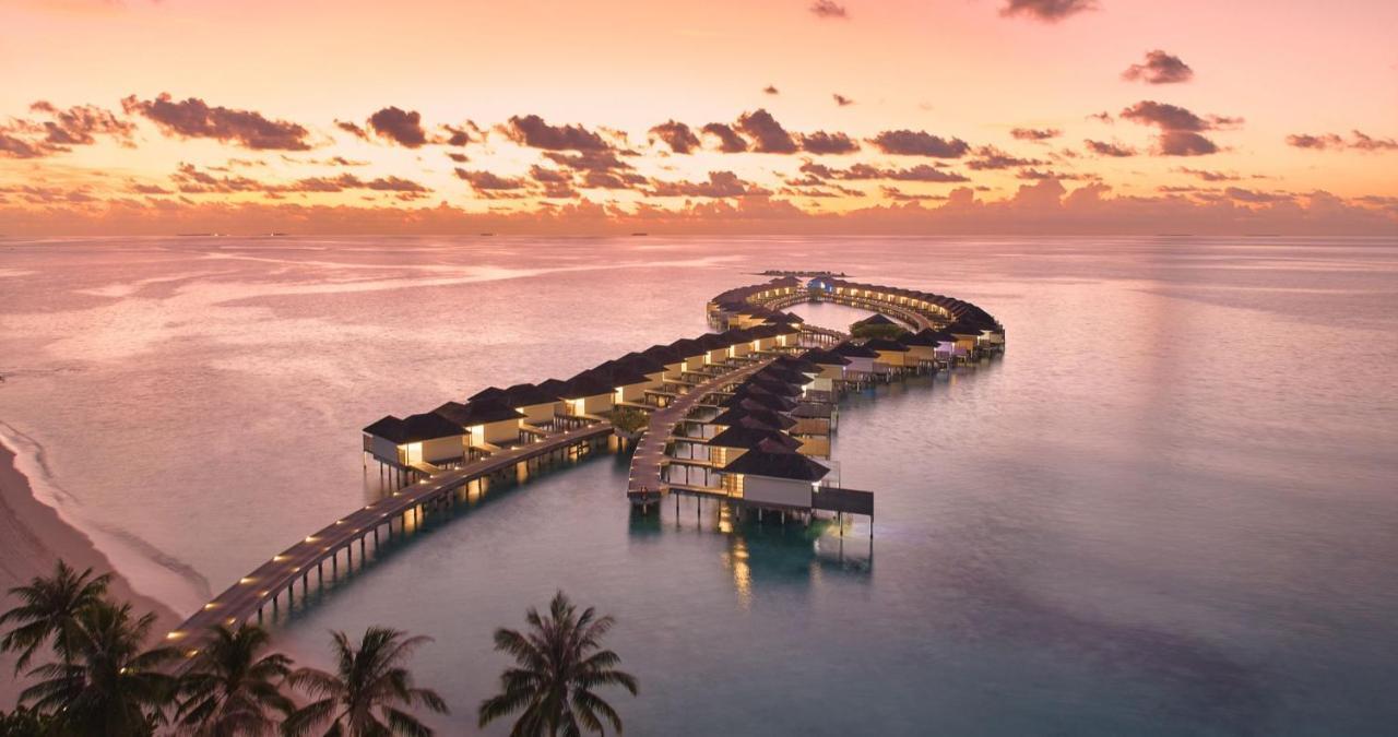 Kandima Maldives Kudahuvadhoo Exterior photo The resort at sunset